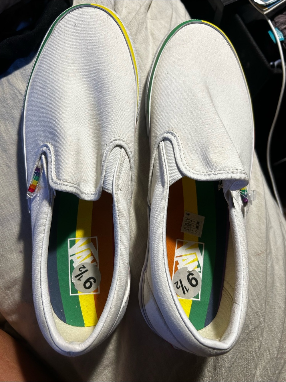 Vans men’s White Slip-On Sneakers with Rainbow Insole
